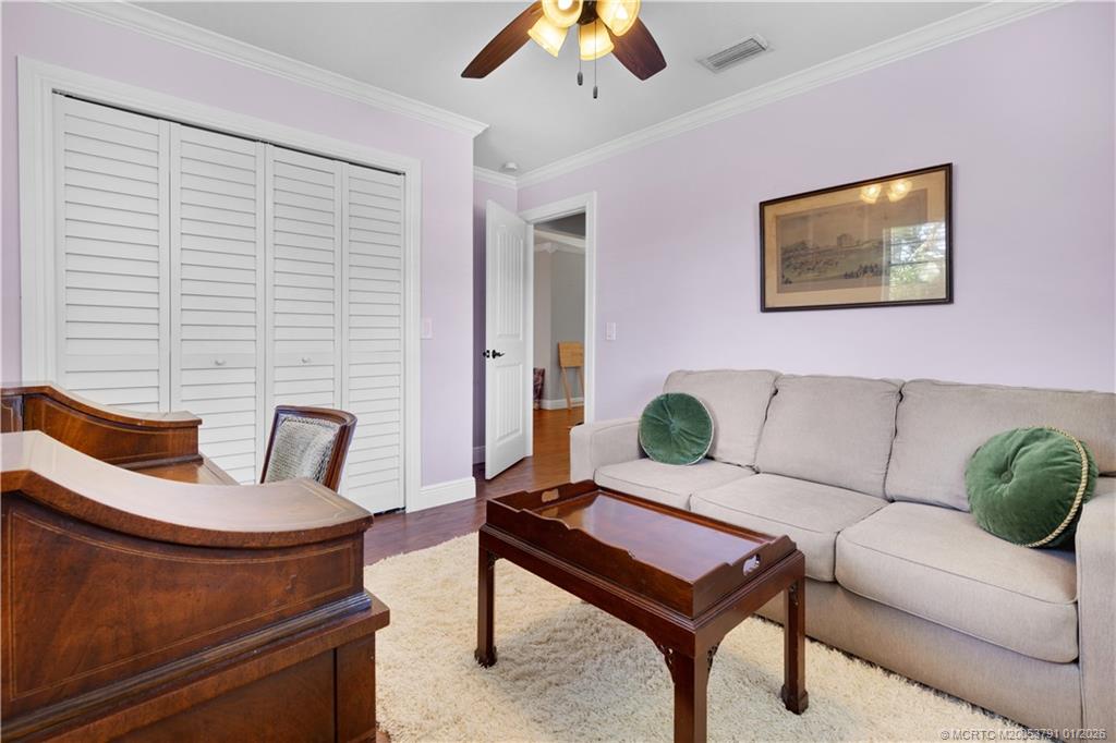2916 Southeast Paramount Place Stuart, FL 34997 - Photo 28 of 38 a living room with furniture and a potted plant