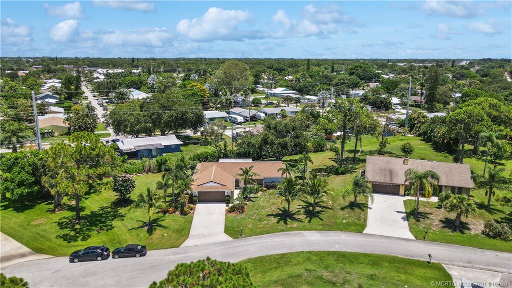 2916 Southeast Paramount Place Stuart, FL 34997 - Photo 32 of 38 an aerial view of residential houses with outdoor space and trees