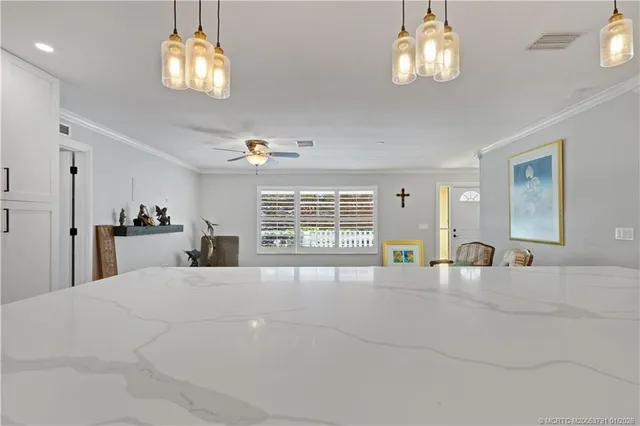 a large bedroom with a bed and a chandelier