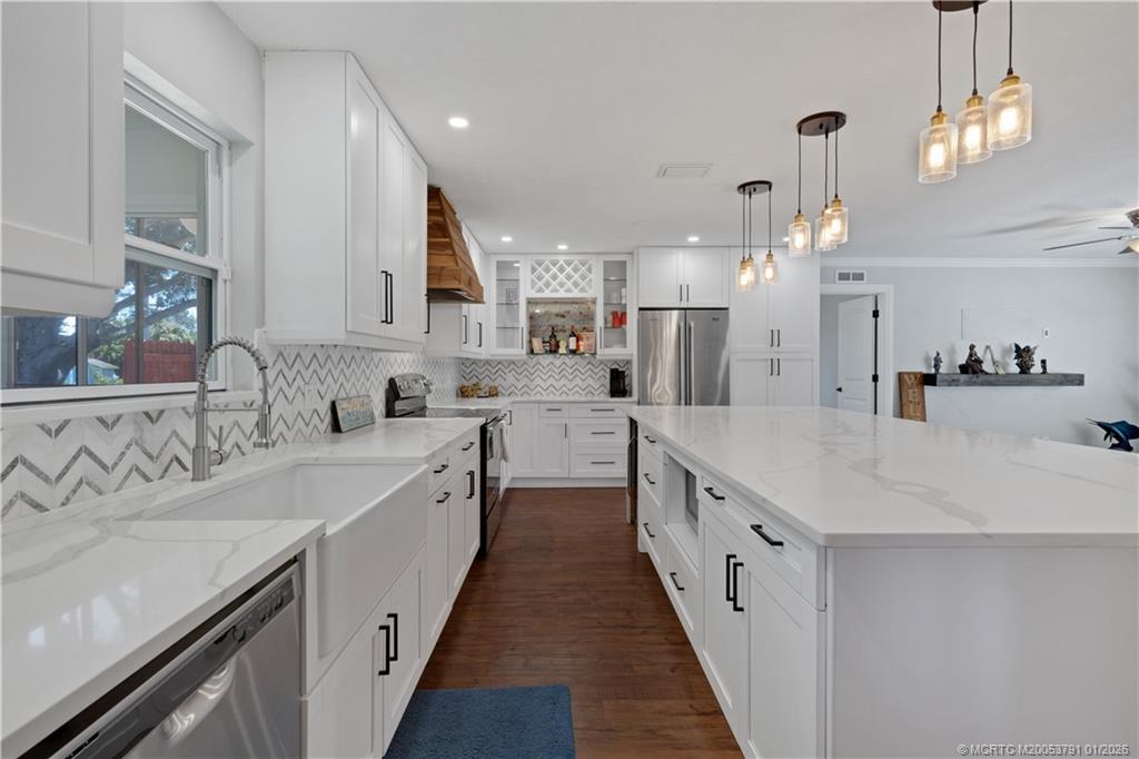 2916 Southeast Paramount Place Stuart, FL 34997 - Photo 10 of 38 a large kitchen with stainless steel appliances lots of counter space and a sink