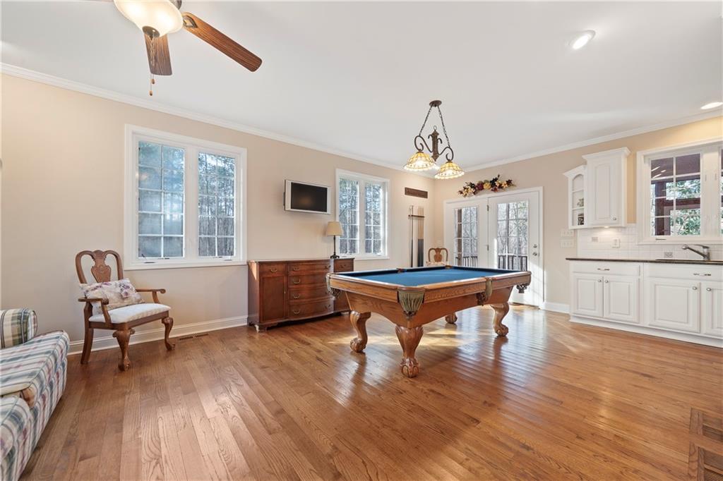 125 Lowe Road Northwest Milledgeville, GA 31061 - Photo 21 of 62 a bedroom with furniture window and wooden floor