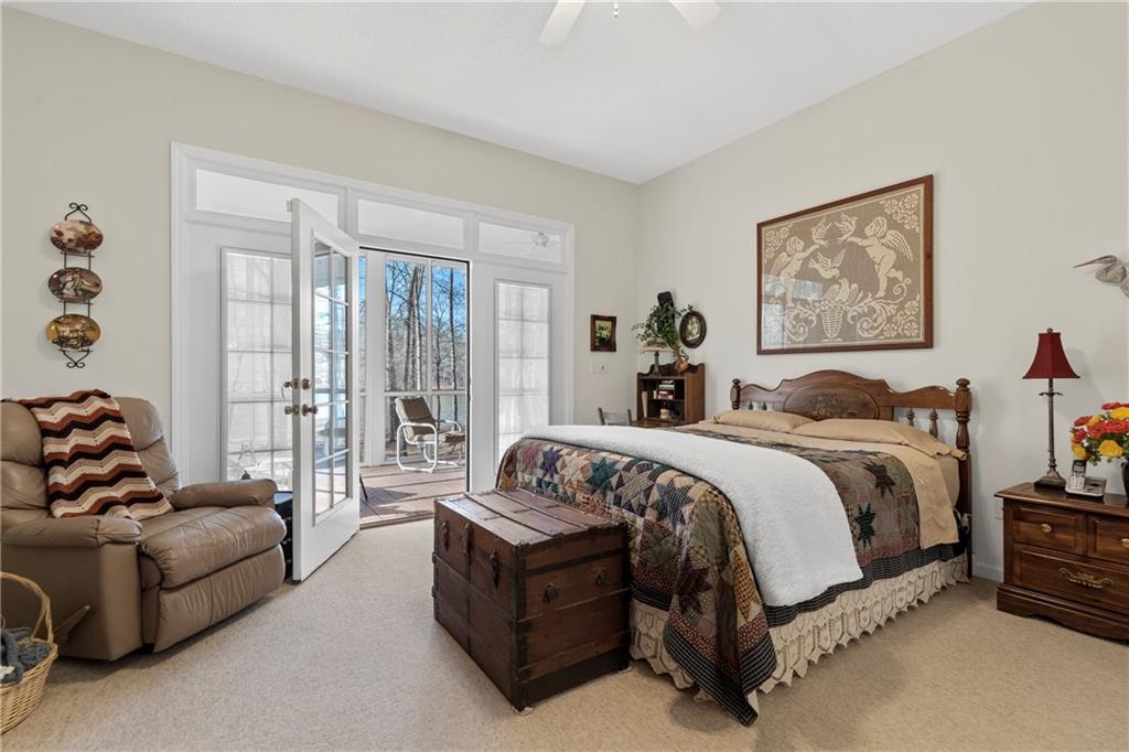 125 Lowe Road Northwest Milledgeville, GA 31061 - Photo 25 of 73 a spacious bedroom with a bed and glass window
