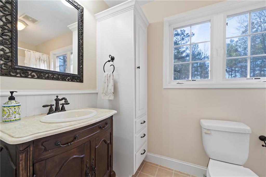 125 Lowe Road Northwest Milledgeville, GA 31061 - Photo 43 of 73 a bathroom with a sink a toilet and a mirror