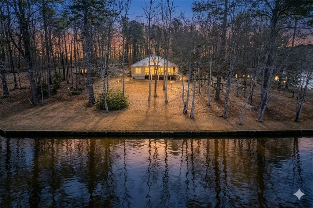 125 Lowe Road Northwest Milledgeville, GA 31061 - Photo 5 of 73 a view of a lake from a yard