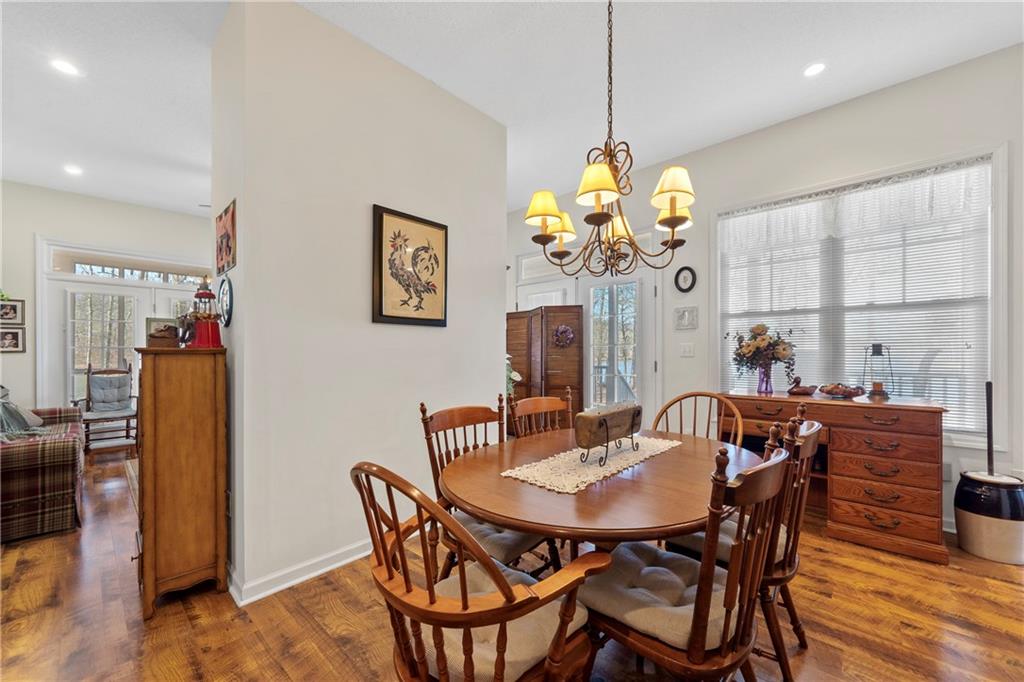 125 Lowe Road Northwest Milledgeville, GA 31061 - Photo 9 of 62 a dining room with furniture potted plants and wooden floor