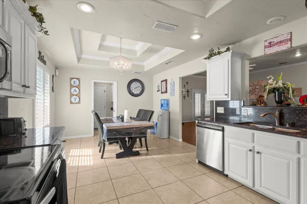 a kitchen with stainless steel appliances kitchen island granite countertop a sink and cabinets
