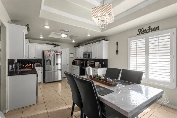 a kitchen with stainless steel appliances kitchen island granite countertop a refrigerator and a stove top oven