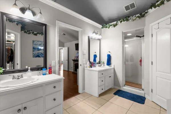 a spacious bathroom with a double vanity sink and a mirror