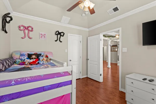 a bedroom with furniture and a flat screen tv