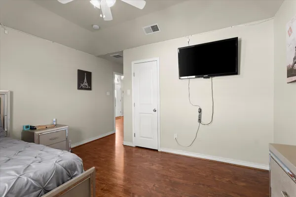 a bedroom with a bed and a flat screen tv