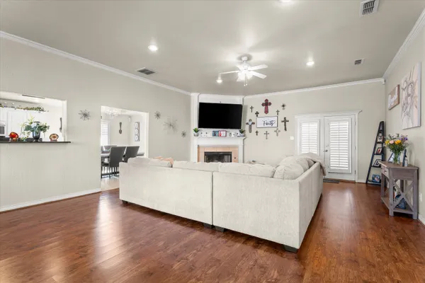 a living room with furniture a flat screen tv and a fireplace