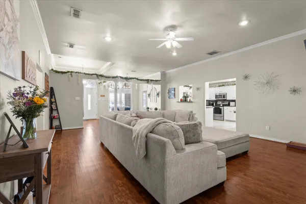 a living room with furniture and wooden floor