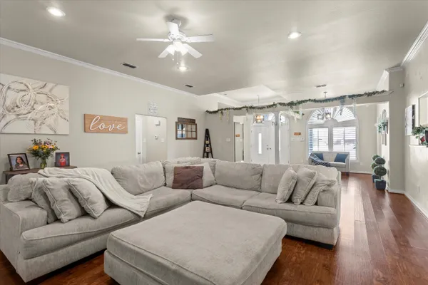 a living room with furniture and wooden floor