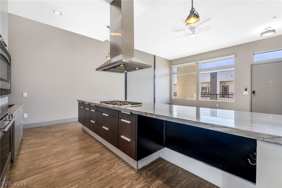 2775 West Pebble Road, Unit 505 Las Vegas, NV 89123 - Photo 7 of 26 Culinary delights await in this sleek kitchen featuring a gas cooktop on a generous island.