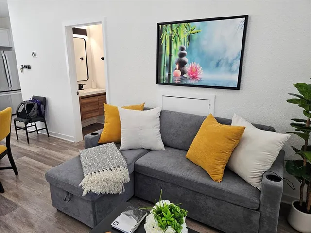 a living room with furniture and wooden floor