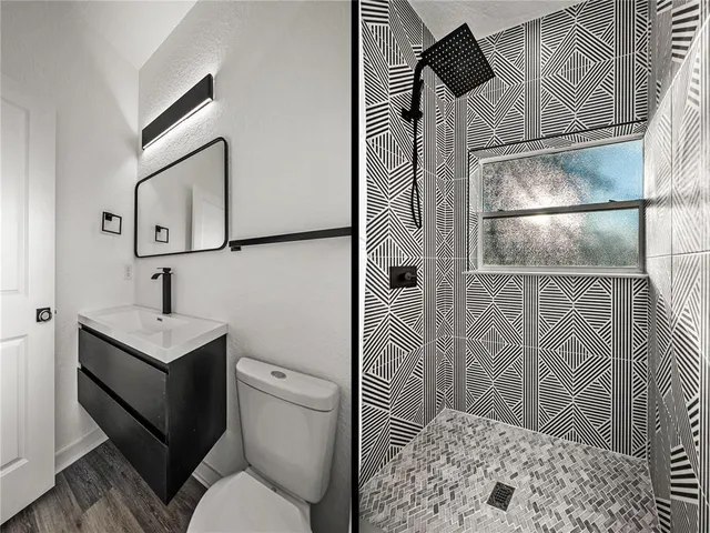 a bathroom with a toilet sink and shower