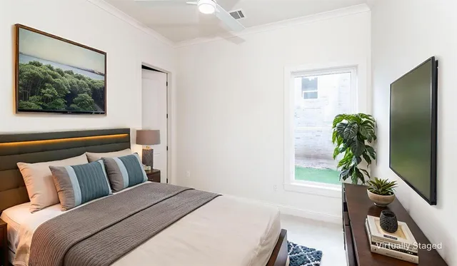 a bedroom with a large bed and a flat screen tv