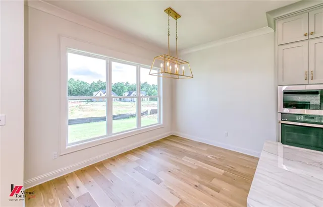 a kitchen with kitchen island granite countertop a sink cabinets and stainless steel appliances
