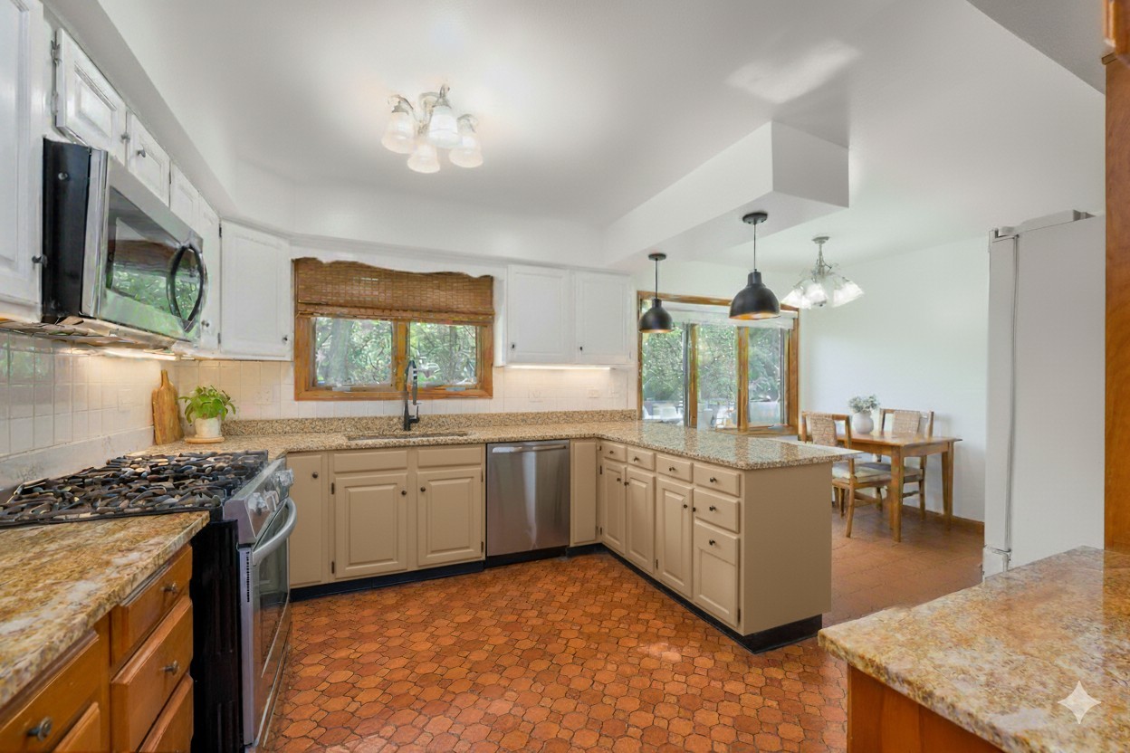 900 Ruth Drive Elgin, IL 60123 - Photo 5 of 25 a kitchen with stainless steel appliances granite countertop a stove a sink dishwasher a dining table and chairs with wooden floor