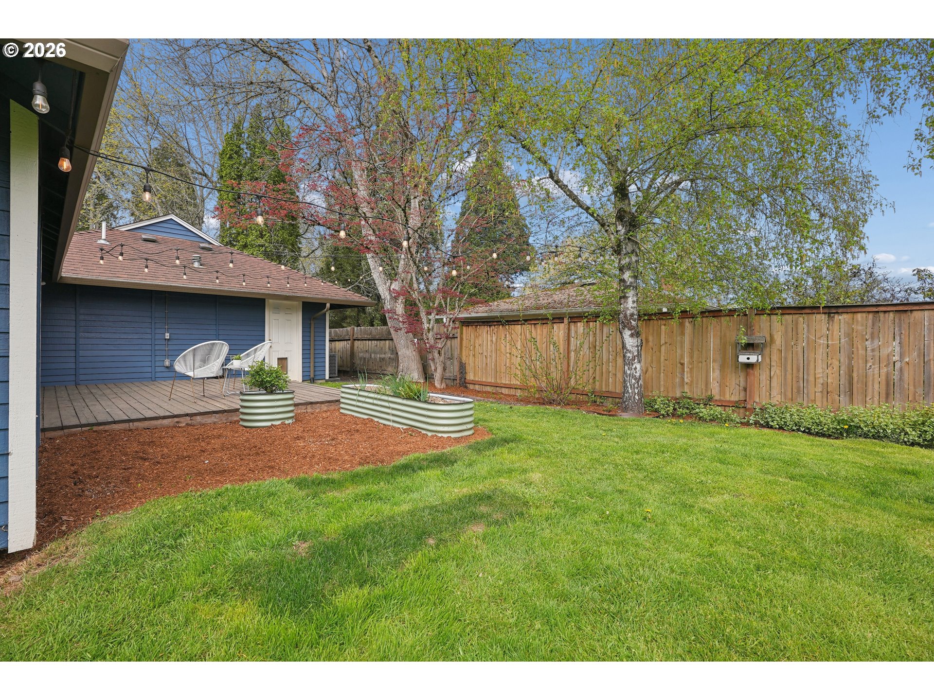 4030 Southwest 188th Avenue Beaverton, OR 97078 - Photo 18 of 20 a backyard of a house with table and chairs