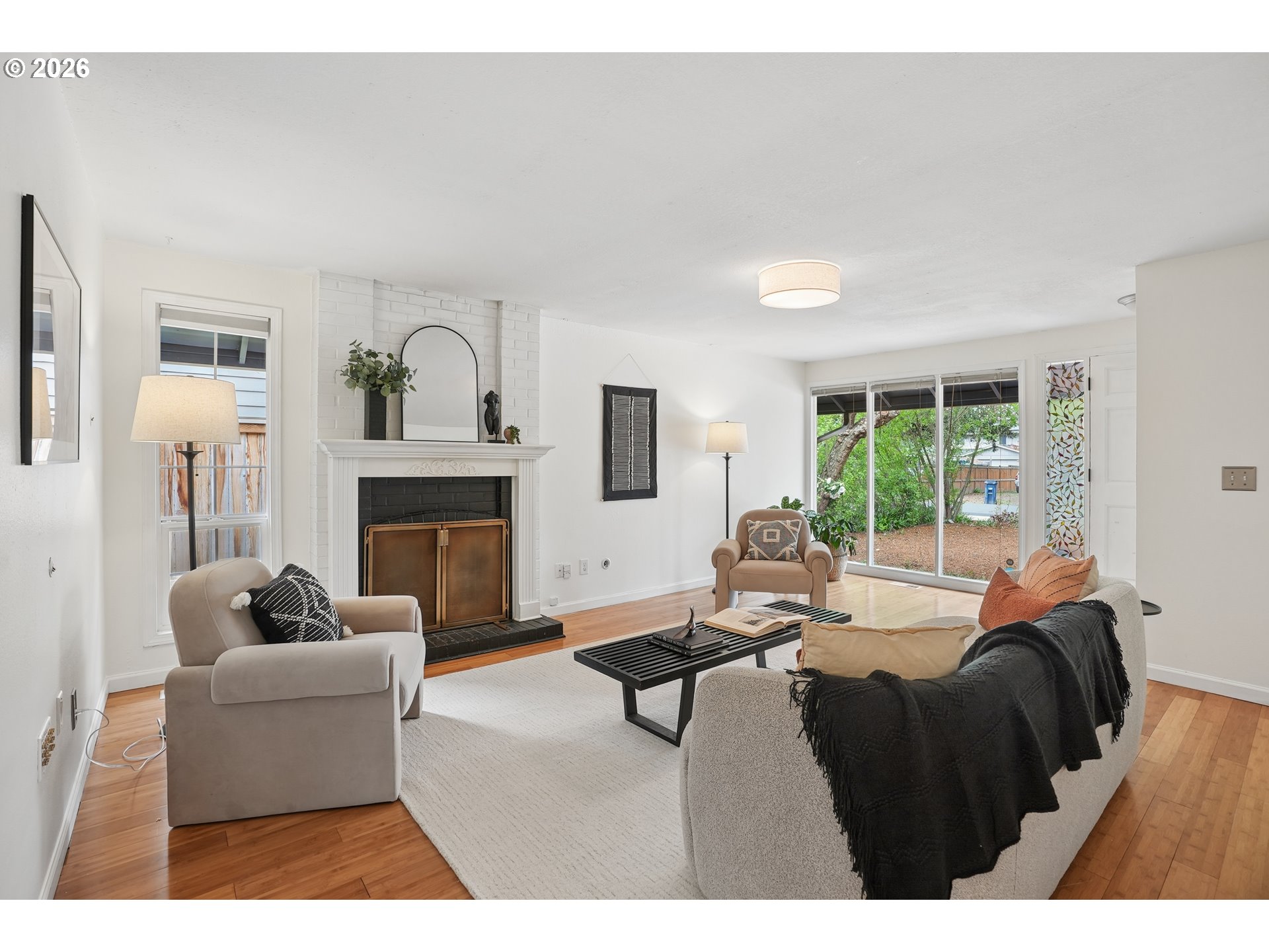 4030 Southwest 188th Avenue Beaverton, OR 97078 - Photo 3 of 20 a living room with furniture a fireplace and a large window