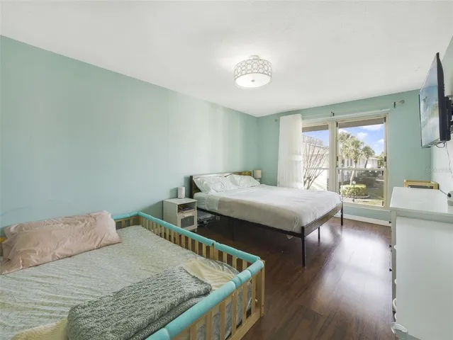 a bedroom with a bed and a large window