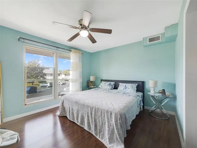 a bedroom with a large bed and a window