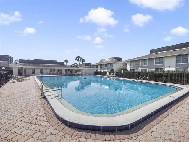 a view of a swimming pool with an outdoor seating