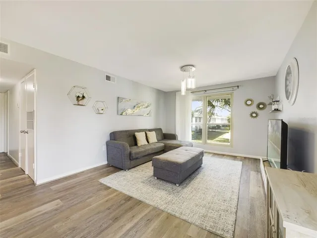 a living room with furniture window and wooden floor