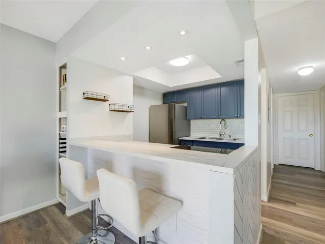 a kitchen with stainless steel appliances a refrigerator and a stove top oven