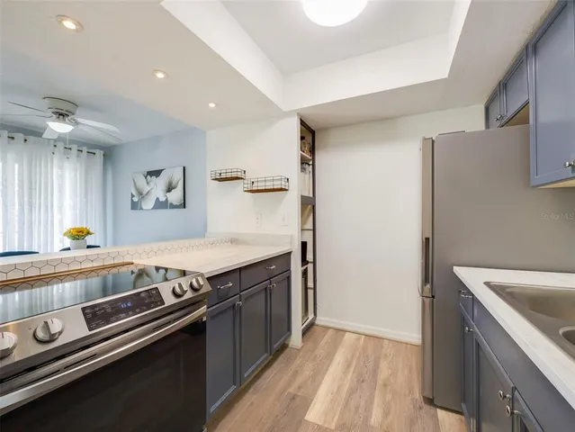 a view of a kitchen with a stove and a refrigerator