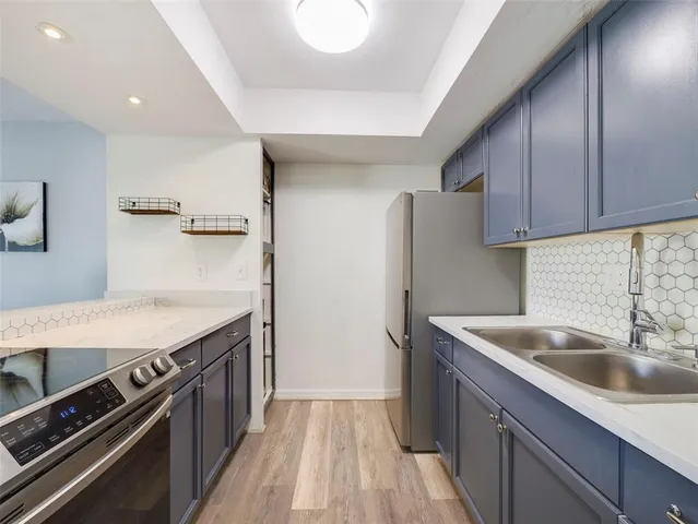 a kitchen that has a sink and a stove