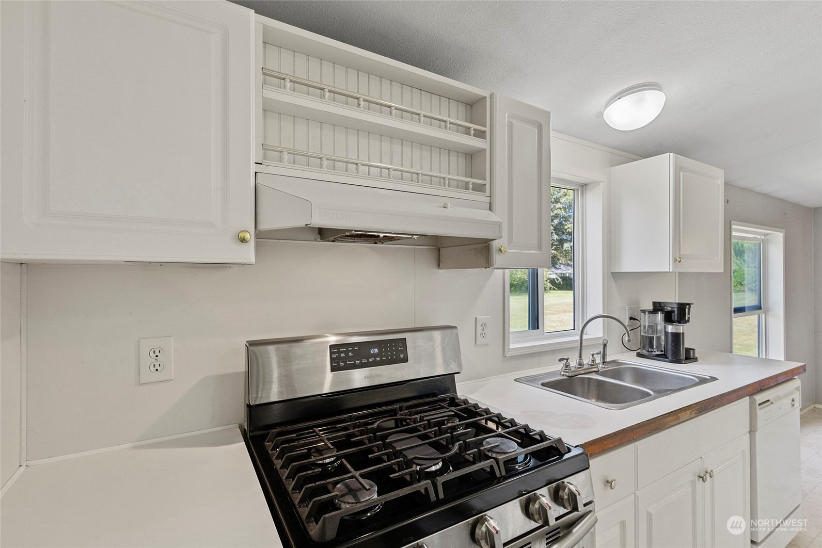 8292 Emmanuel Drive Concrete, WA 98237 - Photo 12 of 40 a kitchen with a stove a sink and cabinets