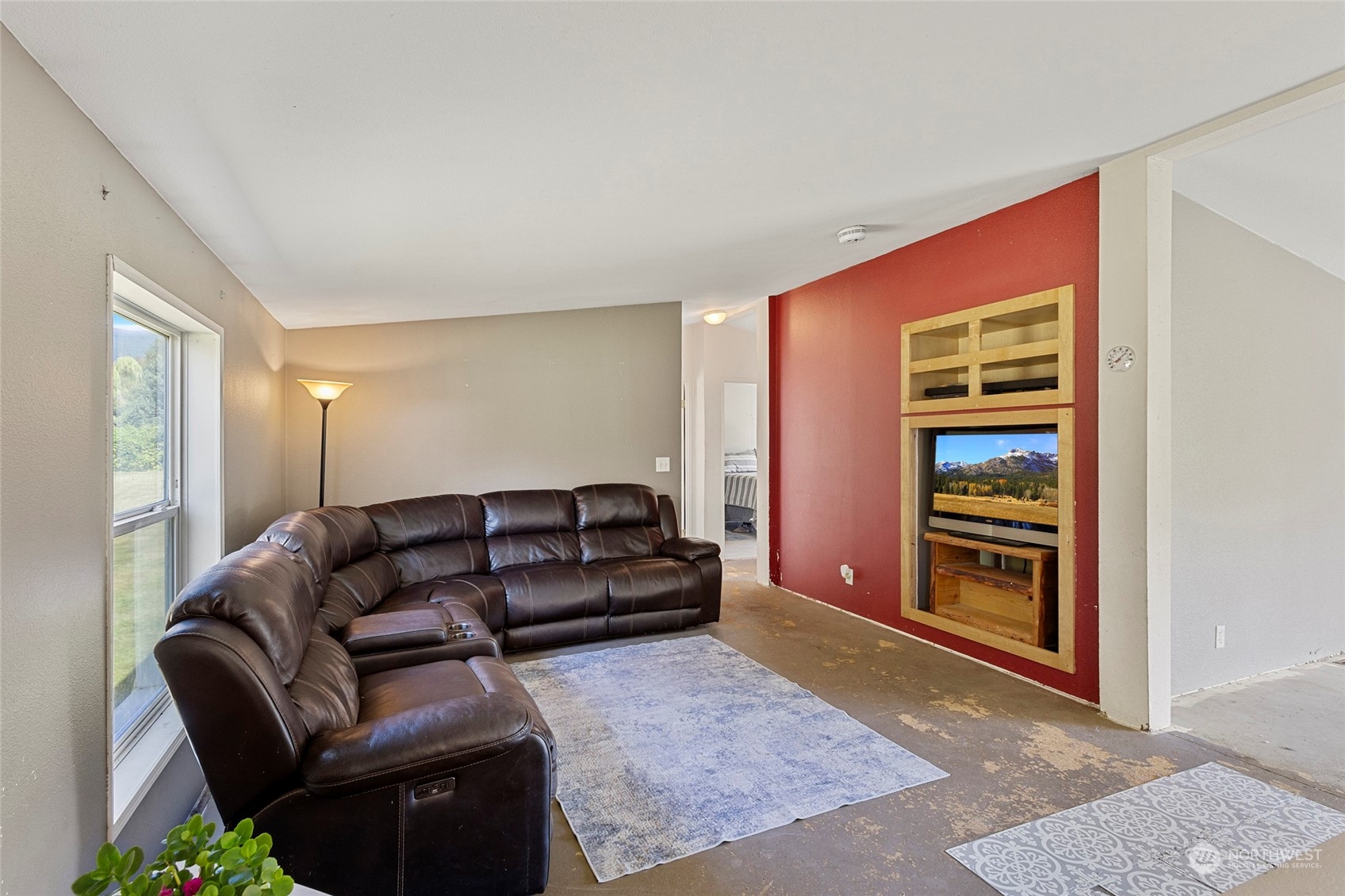 8292 Emmanuel Drive Concrete, WA 98237 - Photo 15 of 40 a living room with furniture and a window