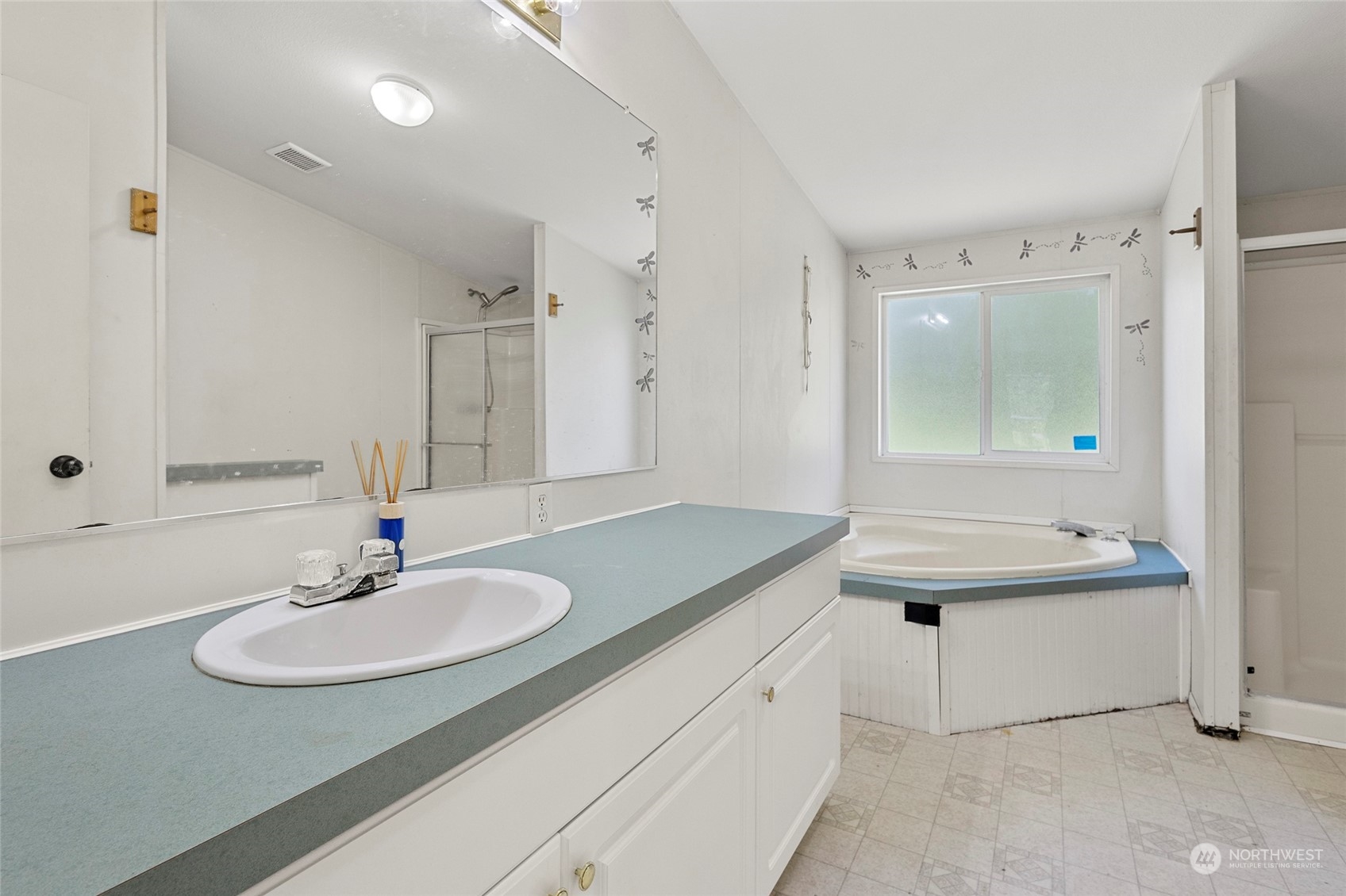 8292 Emmanuel Drive Concrete, WA 98237 - Photo 23 of 40 a bathroom with a sink double vanity granite tub shower and a mirror