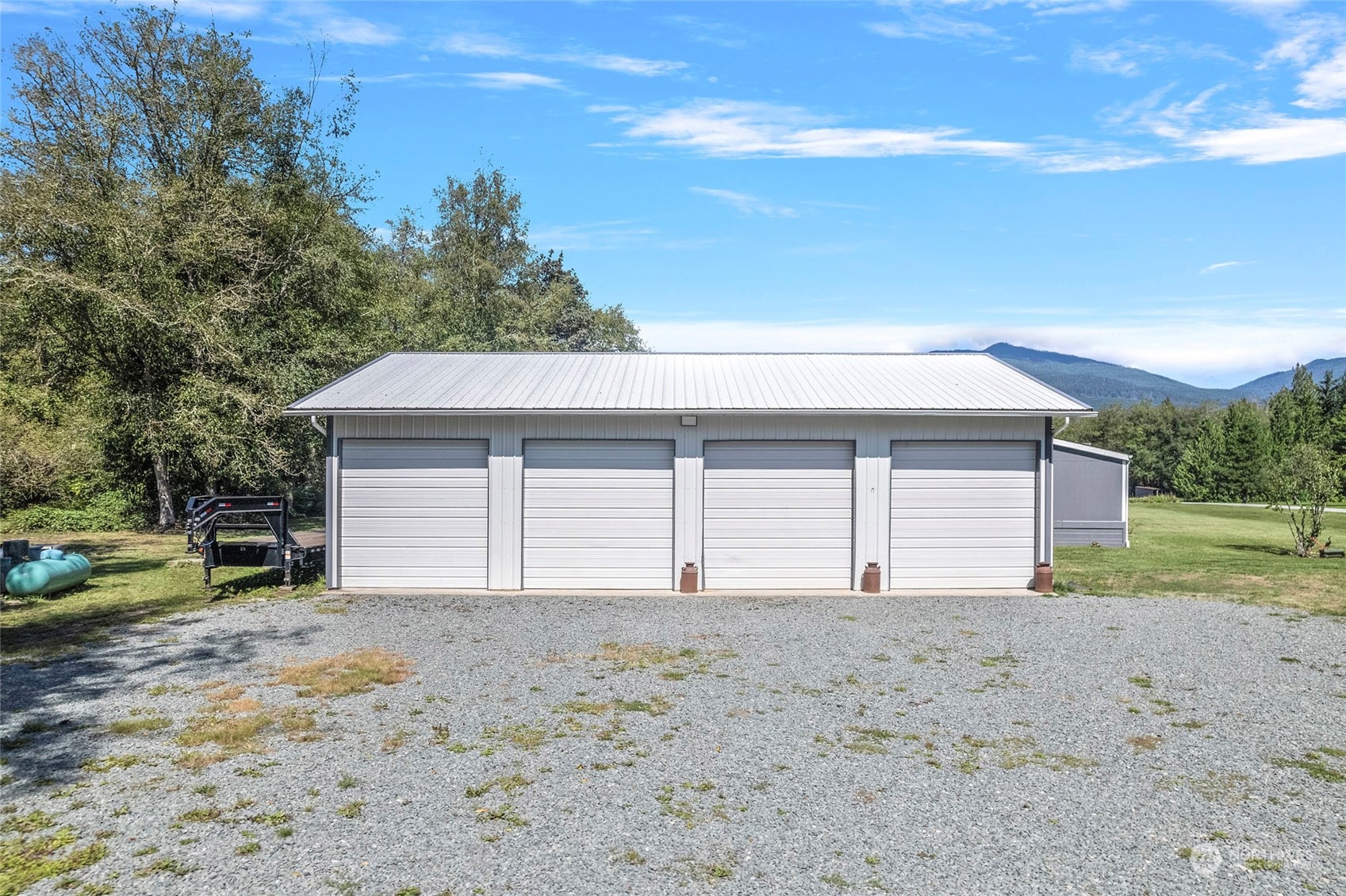 8292 Emmanuel Drive Concrete, WA 98237 - Photo 3 of 40 a view of a house with a yard and garage