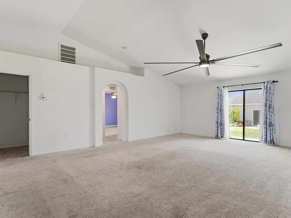 a view of a livingroom with an empty space and a ceiling fan