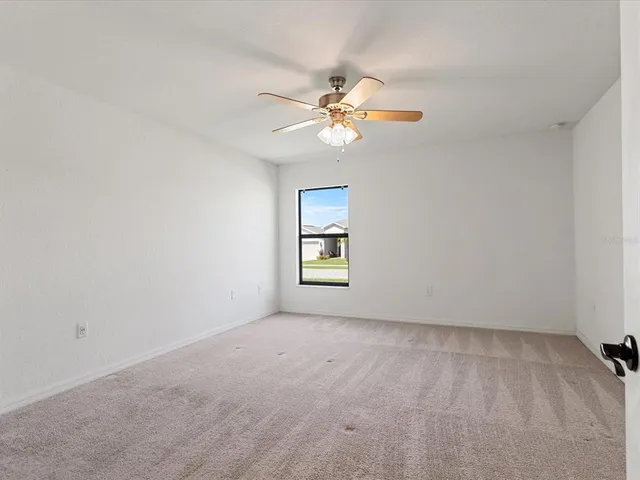 a view of room with a ceiling fan and window