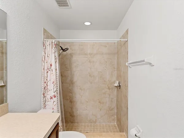 a bathroom with a shower and a toilet