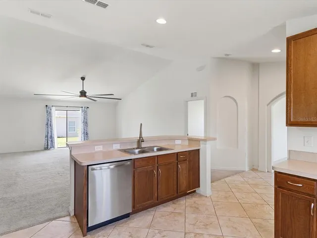 a kitchen with stainless steel appliances granite countertop a sink stove and cabinets