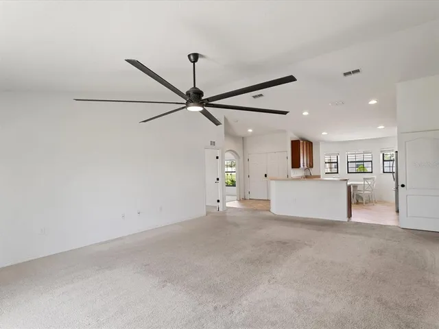 a view of a kitchen with a microwave and a ceiling fan