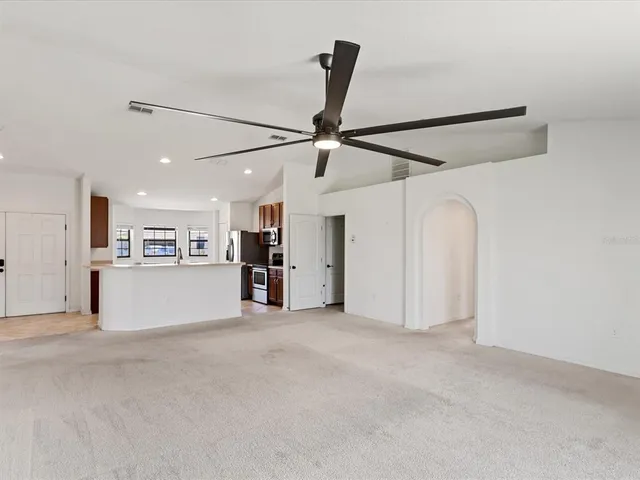 a view of a big room with closet and windows