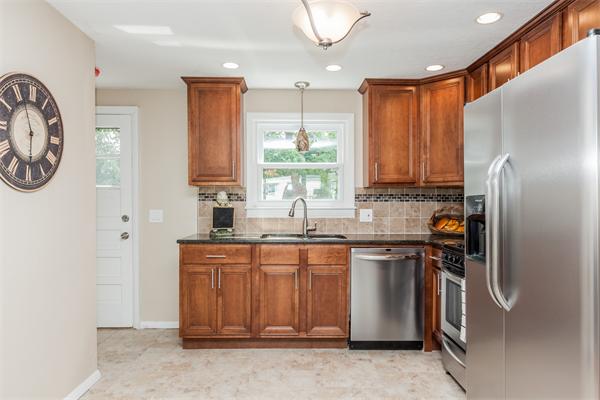 185 Redlands Street Springfield, MA 01104 - Photo 17 of 28 a kitchen with stainless steel appliances granite countertop a refrigerator and a sink