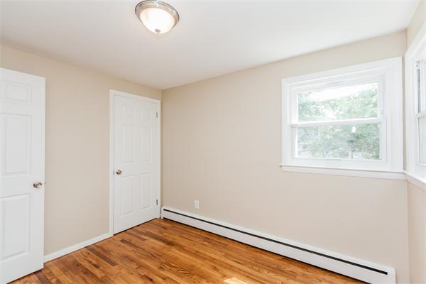 185 Redlands Street Springfield, MA 01104 - Photo 26 of 28 an empty room with wooden floor and windows