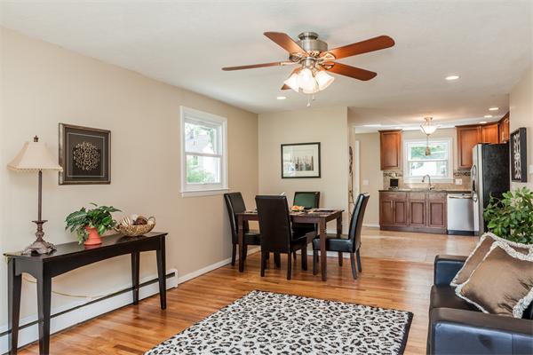 185 Redlands Street Springfield, MA 01104 - Photo 9 of 28 a dining room with wooden floor a chandelier fan a wooden table and chairs