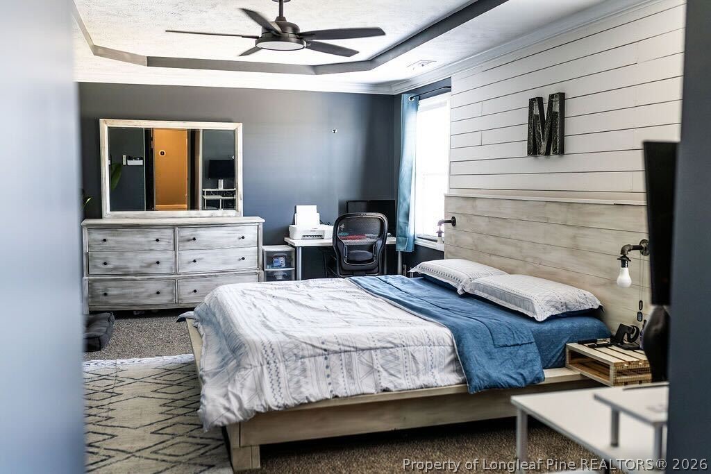 210 McGougan Road Lumber Bridge, NC 28357 - Photo 24 of 47 a bedroom with a bed and a chandelier