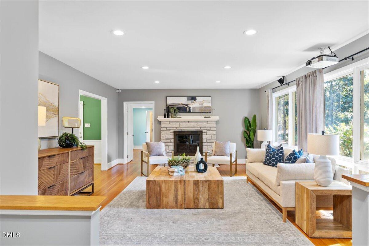 a living room with furniture large window and fireplace