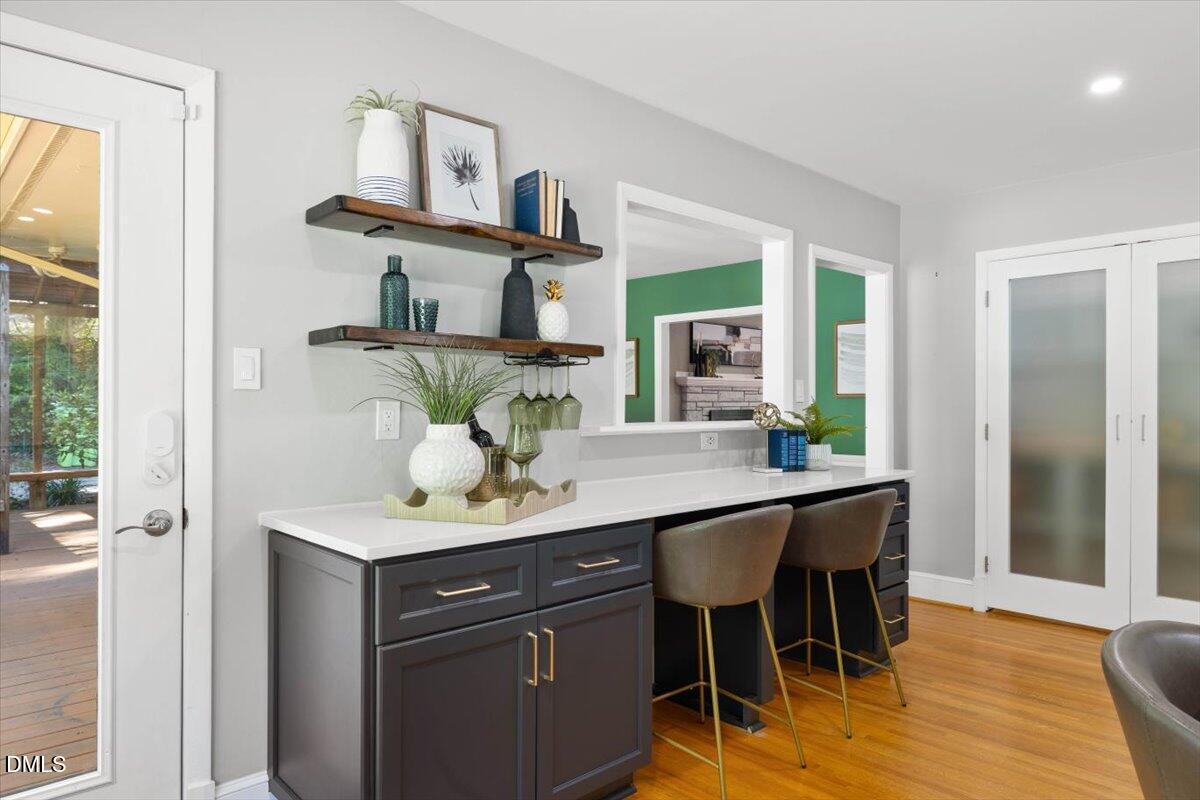 1401 Spring Forest Road Raleigh, NC 27615 - Photo 21 of 47 a view of kitchen island with furniture and wooden floor