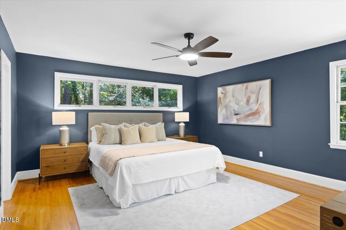 1401 Spring Forest Road Raleigh, NC 27615 - Photo 22 of 47 a bedroom with a large bed and a chandelier