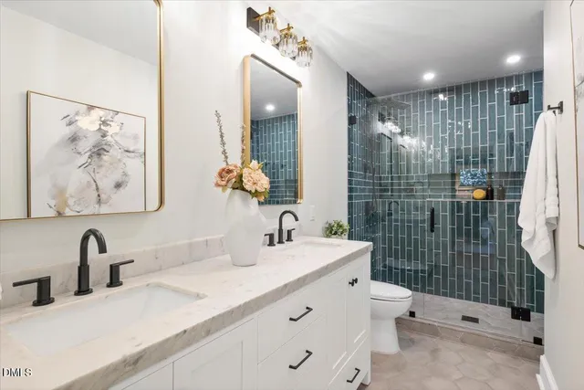 a bathroom with a sink mirror and toilet